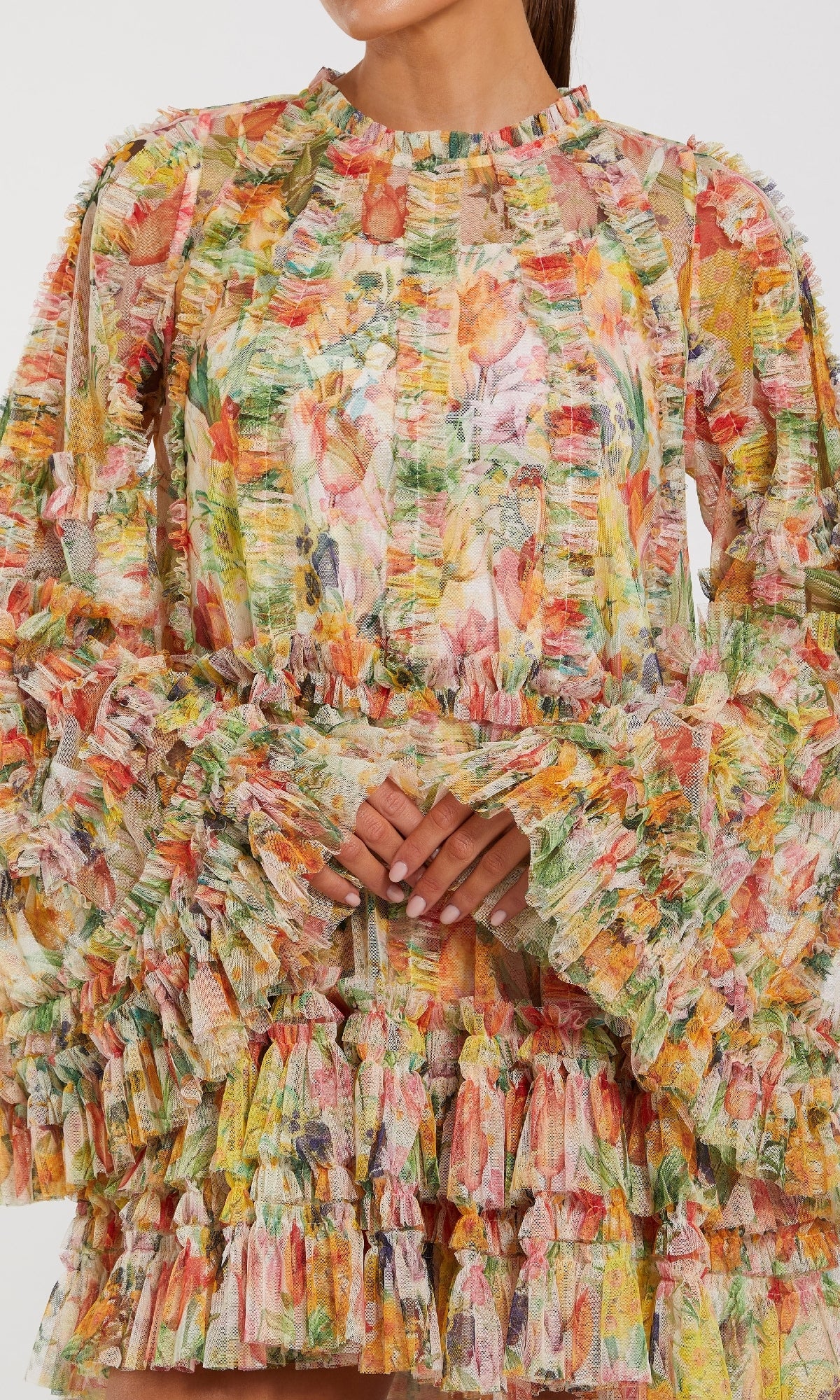 Woman in the Mac Duggal 8300 Bell-Sleeve Floral Wedding Guest Dress, featuring vibrant ruffles and layered textured fabric—a stunning long-sleeve choice for celebrations.